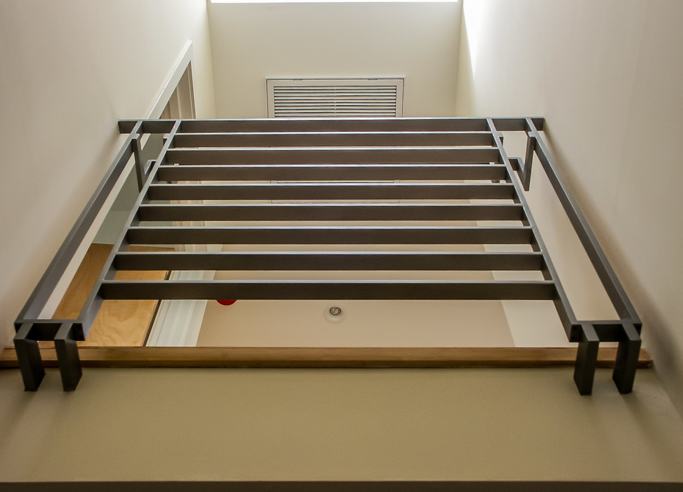 Photo of a mid-sized modern wood u-shaped staircase in Los Angeles with wood risers.