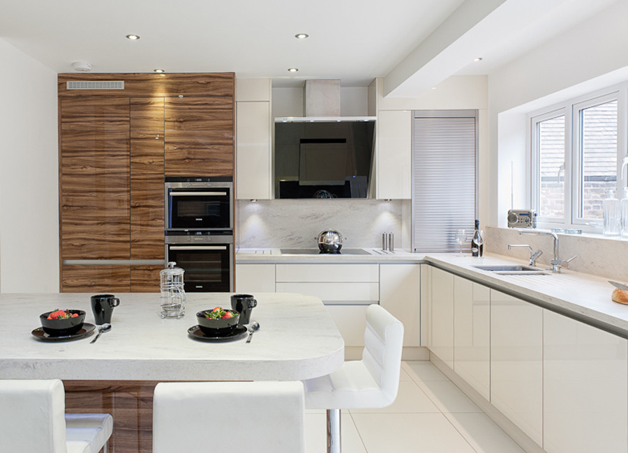Design ideas for a large contemporary l-shaped eat-in kitchen in London with an integrated sink, flat-panel cabinets, light wood cabinets, quartzite benchtops, multi-coloured splashback, stone slab splashback, black appliances, porcelain floors and with island.