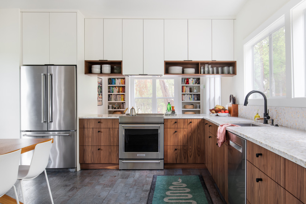 Large midcentury l-shaped eat-in kitchen in Austin with an undermount sink, flat-panel cabinets, terrazzo benchtops, white splashback, stainless steel appliances, cork floors, no island, grey floor and white benchtop.