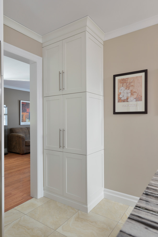 Inspiration for a large transitional u-shaped ceramic tile enclosed kitchen remodel in Toronto with an undermount sink, flat-panel cabinets, dark wood cabinets, granite countertops, beige backsplash, matchstick tile backsplash, stainless steel appliances and an island