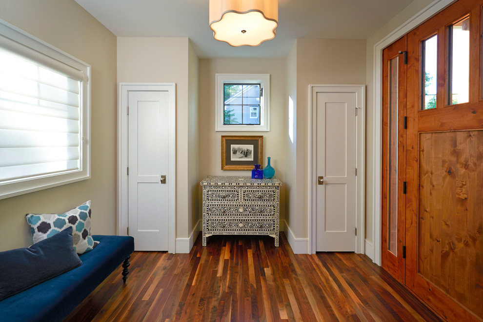 Inspiration for a mid-sized transitional medium tone wood floor foyer remodel in Denver with beige walls and a medium wood front door