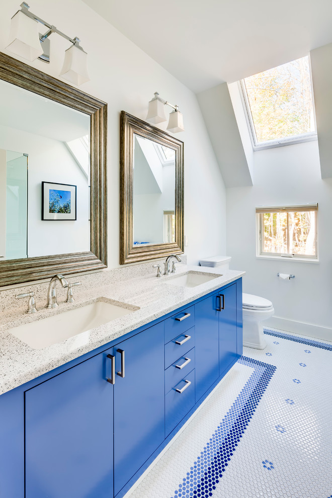Inspiration for a transitional bathroom in Portland Maine with flat-panel cabinets, blue cabinets, multi-coloured tile, mosaic tile, a two-piece toilet, an undermount sink, white walls, mosaic tile floors and blue floor.