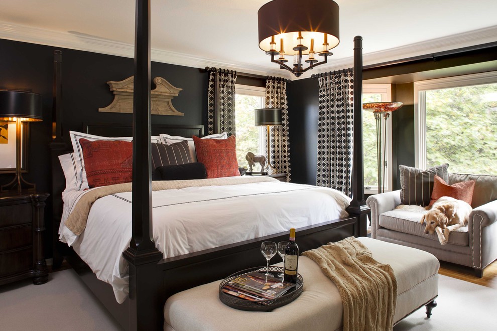 Photo of a traditional bedroom in Kansas City with black walls and medium hardwood floors.