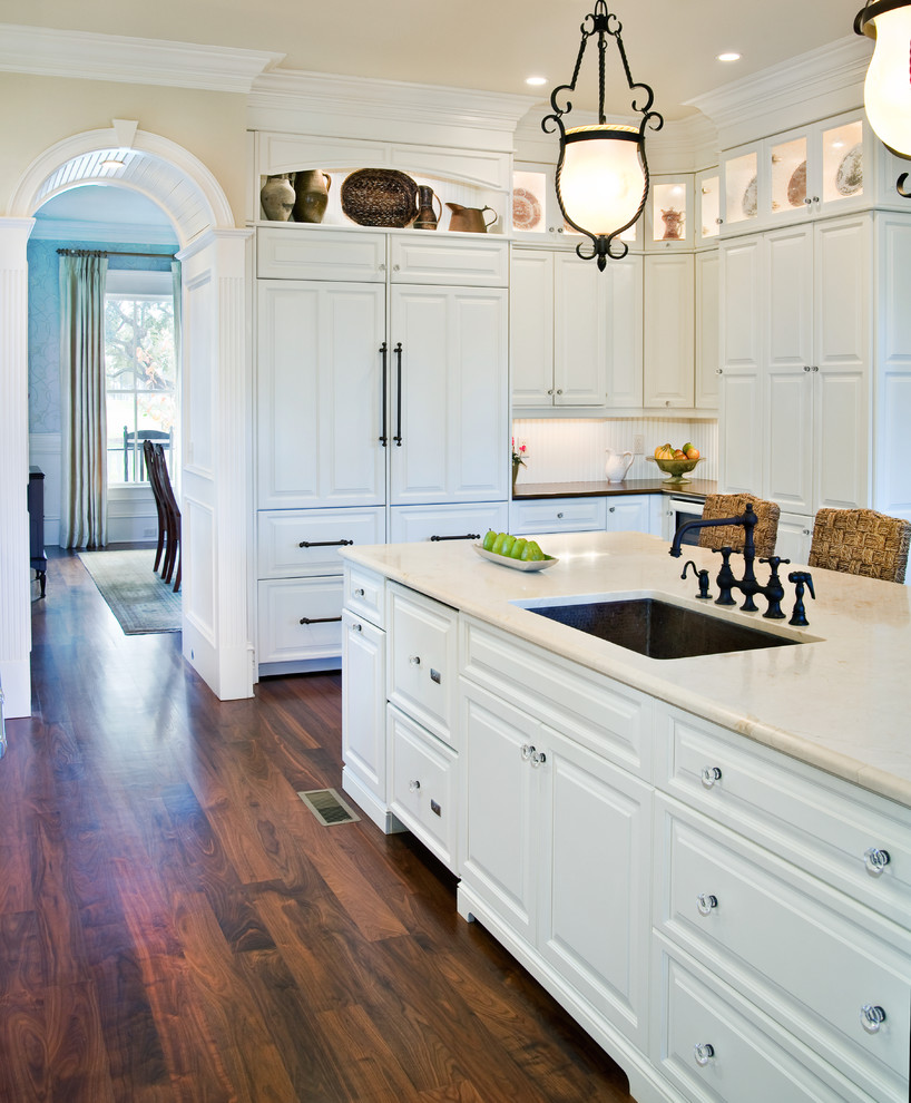 Photo of a traditional kitchen in Charleston with glass-front cabinets.