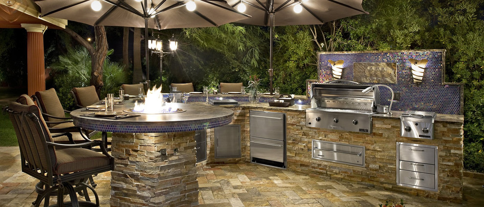 Inspiration for a large contemporary backyard patio in Tampa with an outdoor kitchen, stamped concrete and a roof extension.