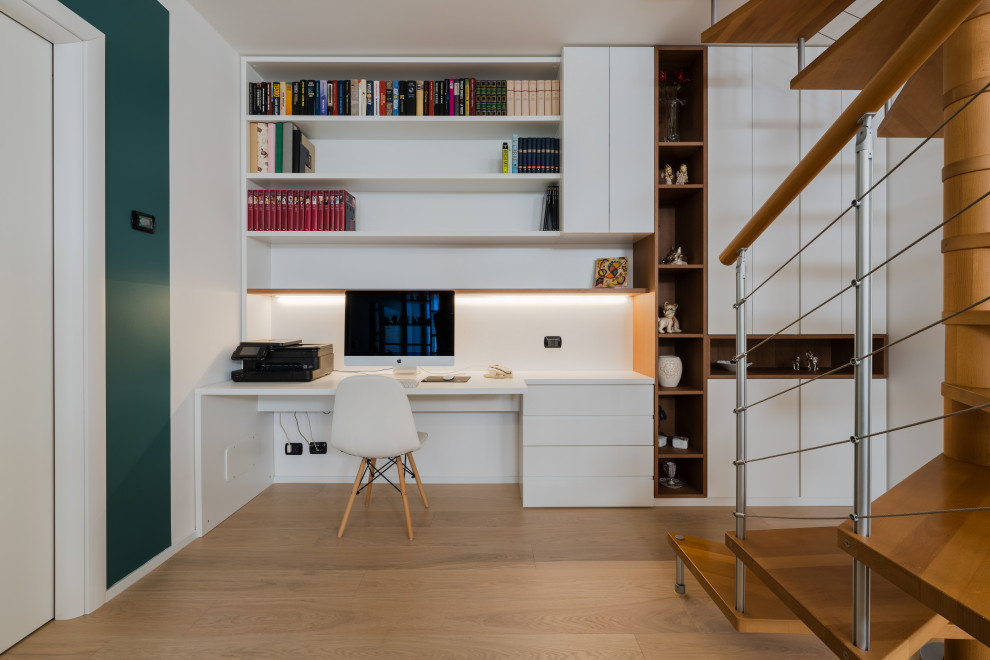 Inspiration for a mid-sized contemporary look-out basement in Milan with multi-coloured walls, light hardwood floors and beige floor.
