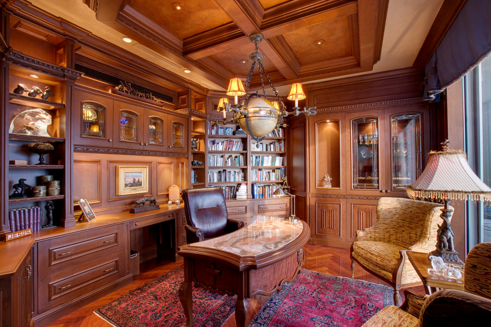 This is an example of a traditional study room in Other with brown walls, medium hardwood floors, no fireplace, a freestanding desk and brown floor.