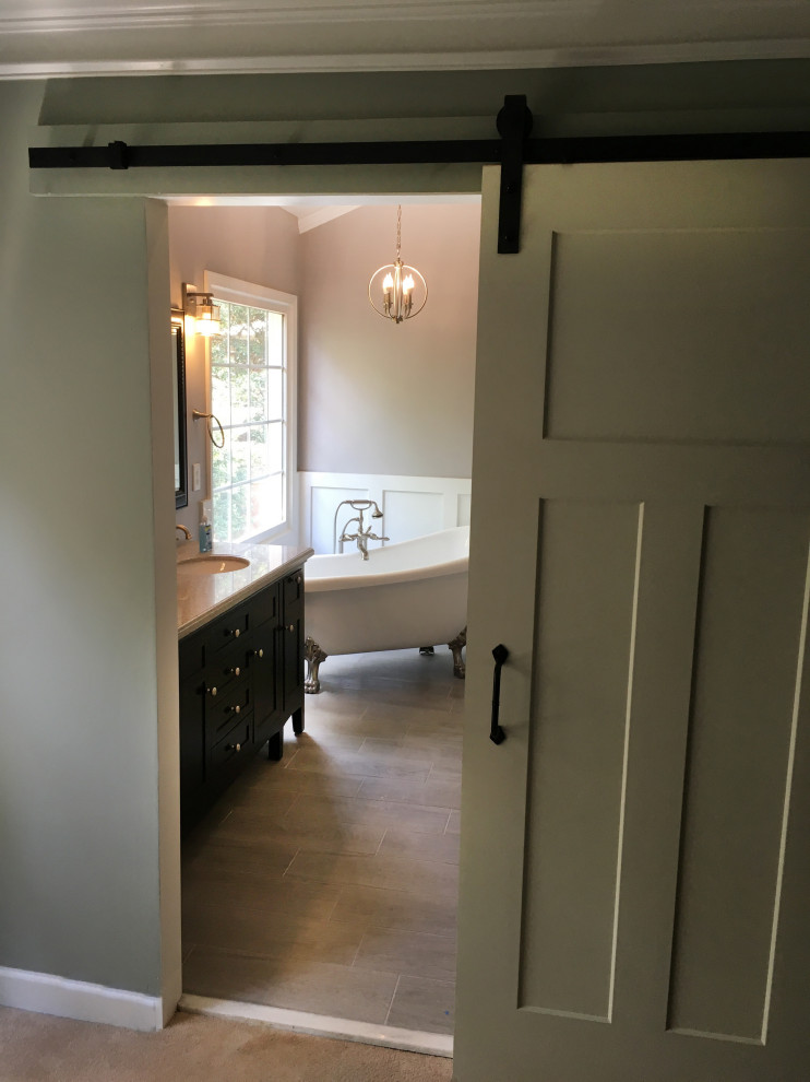 This is an example of a large arts and crafts master bathroom in Atlanta with shaker cabinets, black cabinets, a claw-foot tub, an alcove shower, black and white tile, cement tile, grey walls, cement tiles, an undermount sink, marble benchtops, grey floor, a hinged shower door and white benchtops.