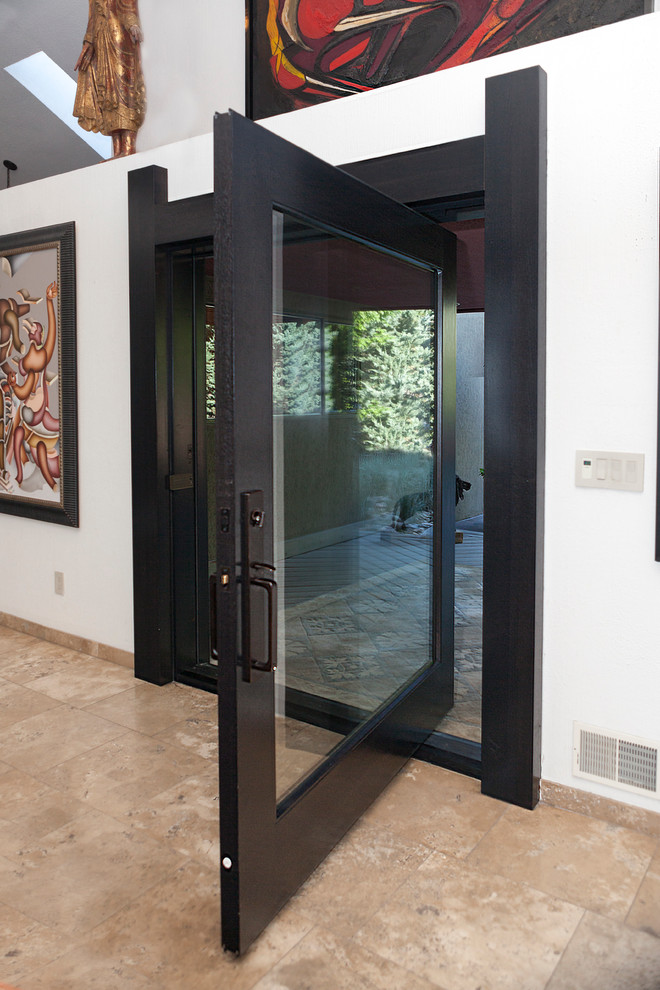 This is an example of a large modern front door in Denver with white walls, travertine floors, a pivot front door, a glass front door and beige floor.