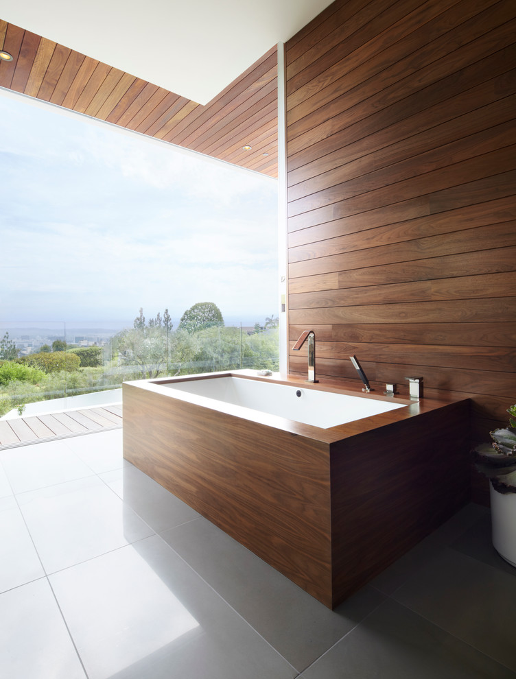 Contemporary bathroom in Los Angeles with an undermount tub, brown walls and ceramic floors.