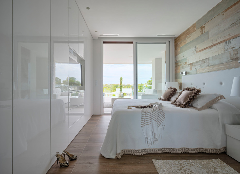 This is an example of a mid-sized contemporary master bedroom in Malaga with no fireplace, brown floor and brown walls.