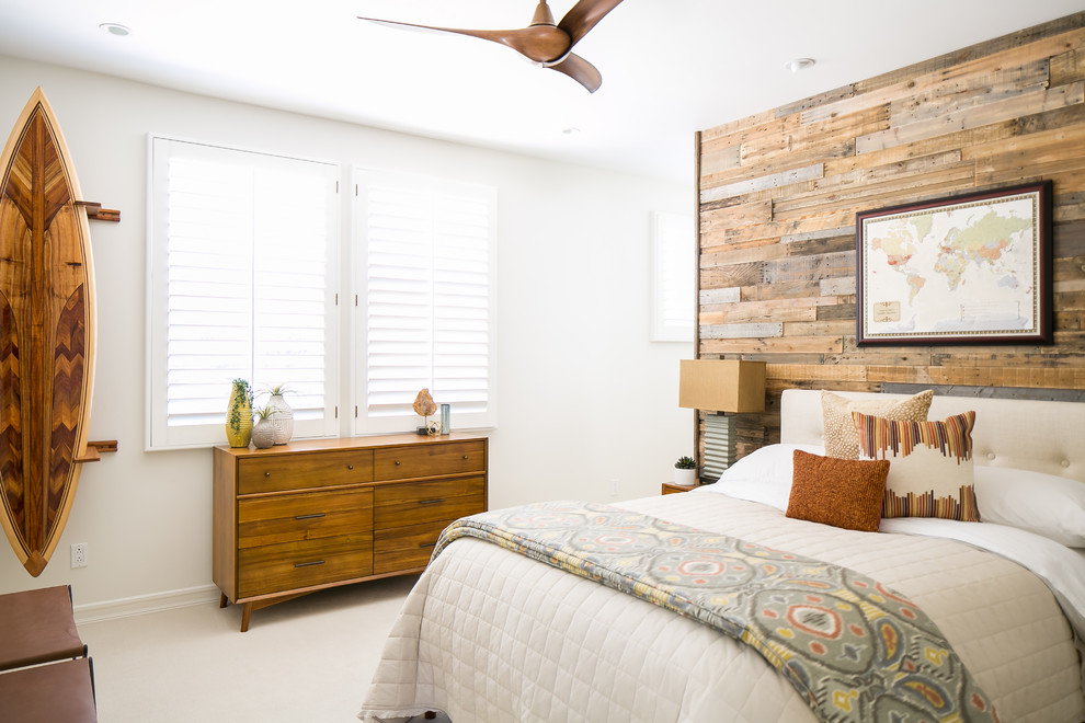 This is an example of a mid-sized transitional guest bedroom in San Diego with white walls, carpet and beige floor.
