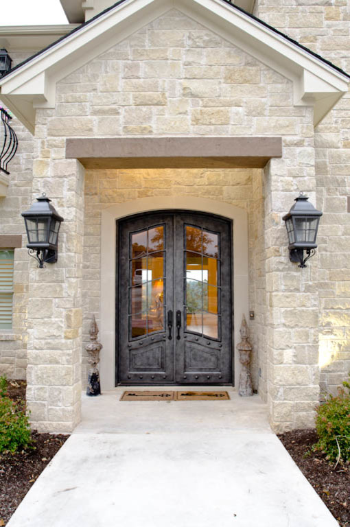 Inspiration for an expansive traditional two-storey beige exterior in Austin with stone veneer and a gable roof.