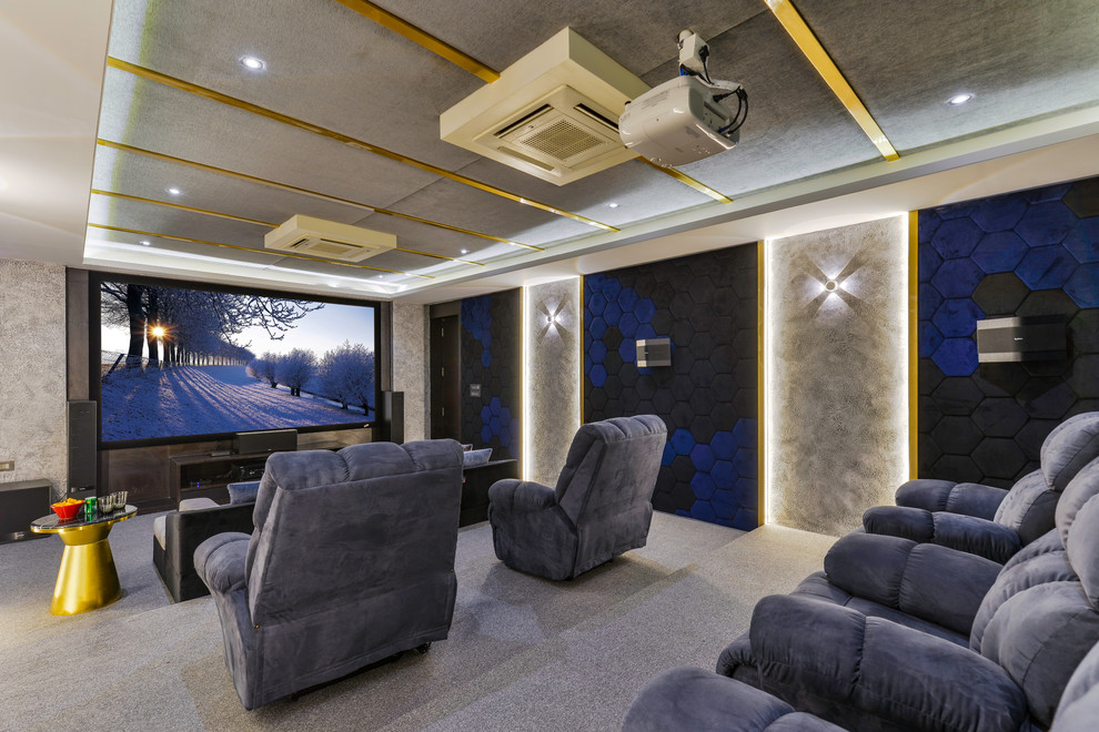 Transitional enclosed home theatre in Bengaluru with beige walls, carpet, a projector screen and grey floor.
