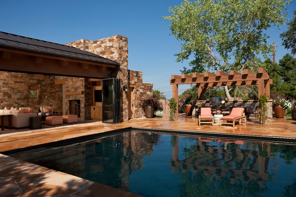 Inspiration for a large country backyard rectangular natural pool in Albuquerque with natural stone pavers.
