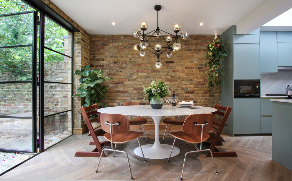 Mid-sized contemporary kitchen/dining combo in London with light hardwood floors, white floor, multi-coloured walls and no fireplace.