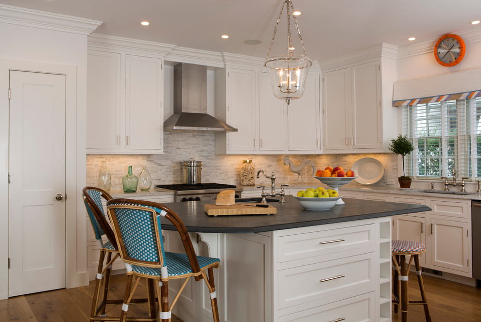 Photo of a beach style l-shaped kitchen in Boston with an undermount sink, shaker cabinets, white cabinets, multi-coloured splashback, stainless steel appliances, medium hardwood floors, with island and mosaic tile splashback.
