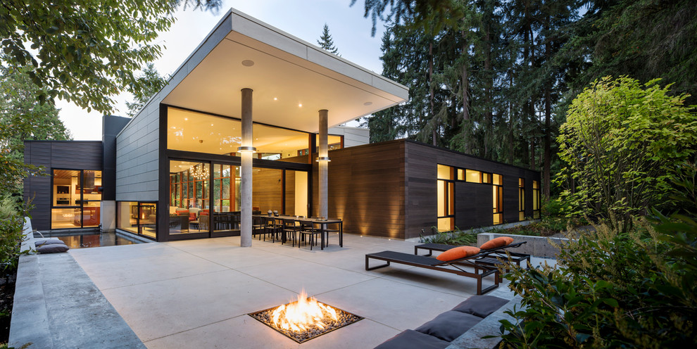 Contemporary patio in Seattle with a fire feature and a roof extension.