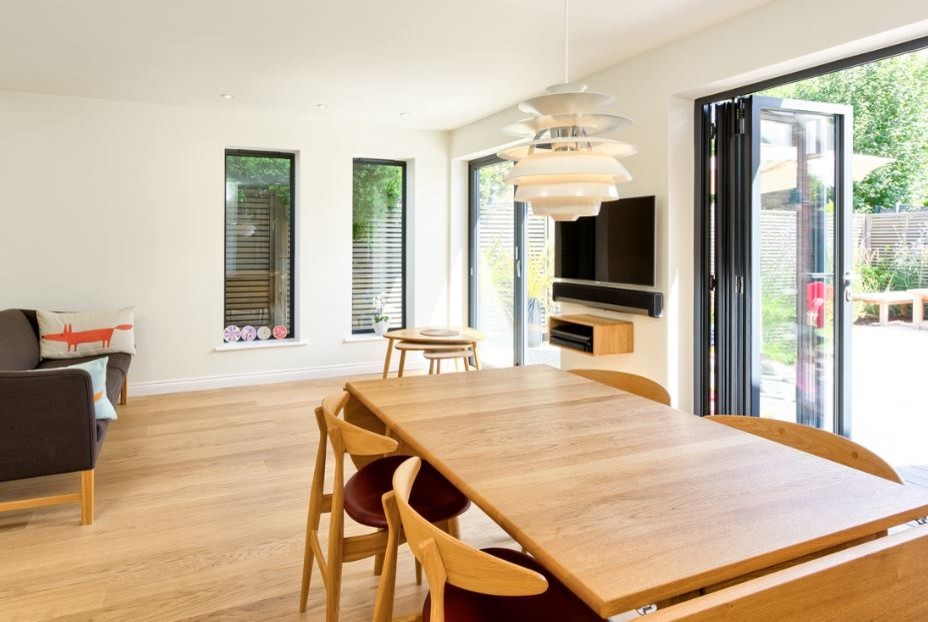 This is an example of a mid-sized scandinavian dining room in Hertfordshire with white walls and light hardwood floors.