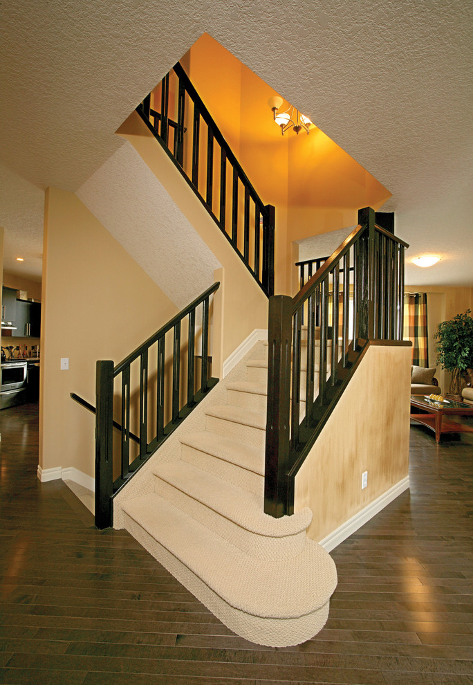 This is an example of a large contemporary carpeted l-shaped staircase in Calgary with carpet risers.