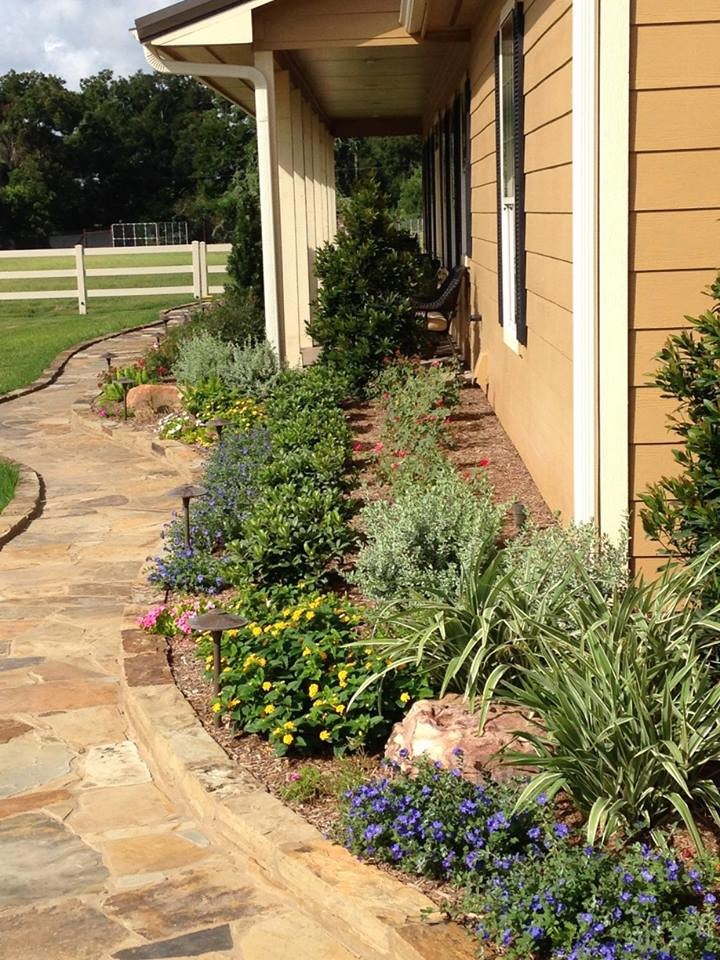 Design ideas for a large traditional backyard garden in Houston with natural stone pavers.