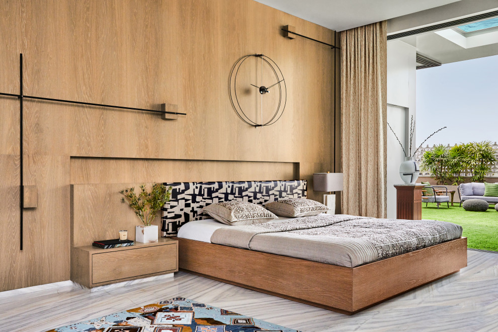 Photo of a contemporary bedroom in Mumbai with brown walls, grey floor and wood walls.