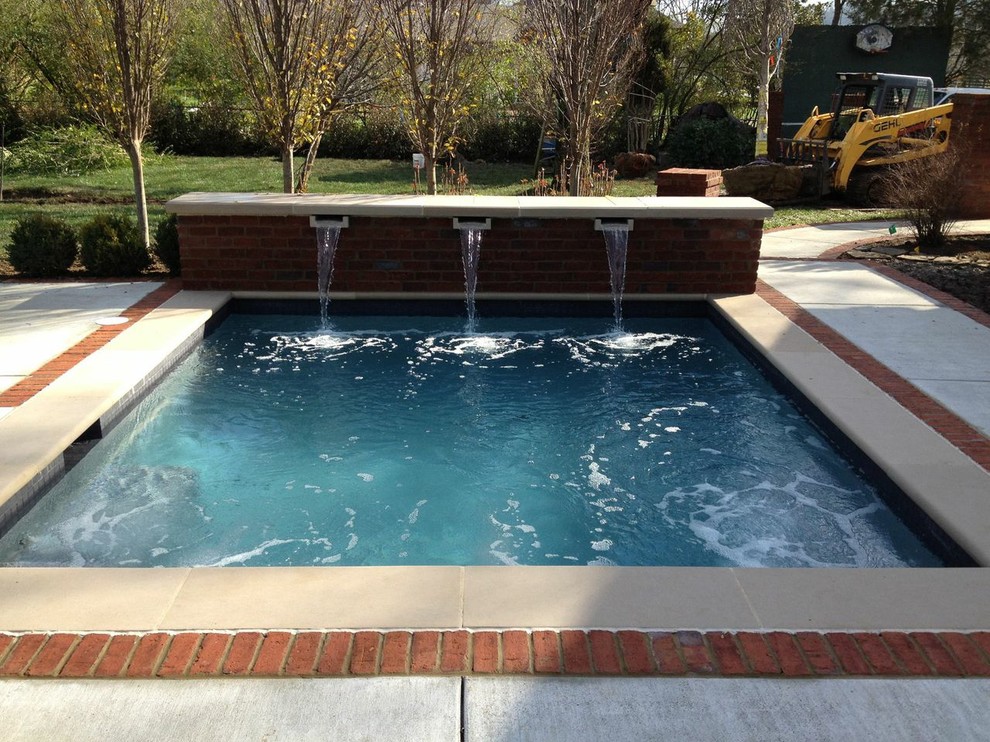 This is an example of a large traditional backyard rectangular natural pool in Nashville with natural stone pavers.