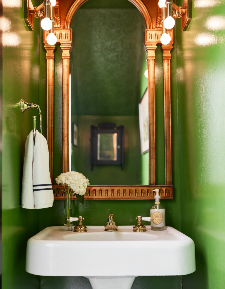 Small traditional powder room in St Louis with marble floors, black floor, white cabinets, green walls, a pedestal sink, a freestanding vanity and vaulted.