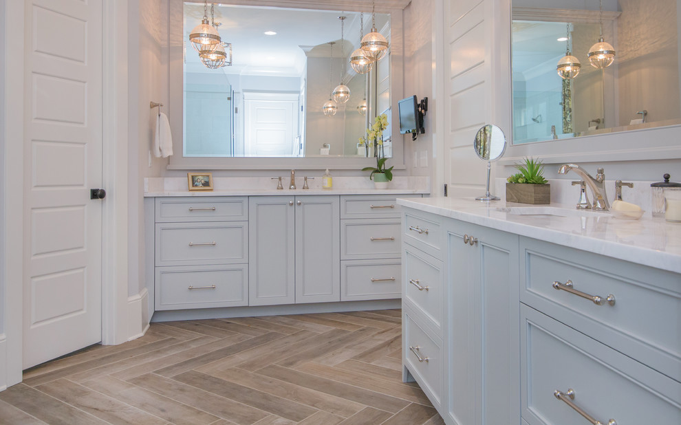 Design ideas for a large transitional master bathroom in Charlotte with flat-panel cabinets, grey cabinets, white walls, porcelain floors, an undermount sink, engineered quartz benchtops, brown floor and white benchtops.