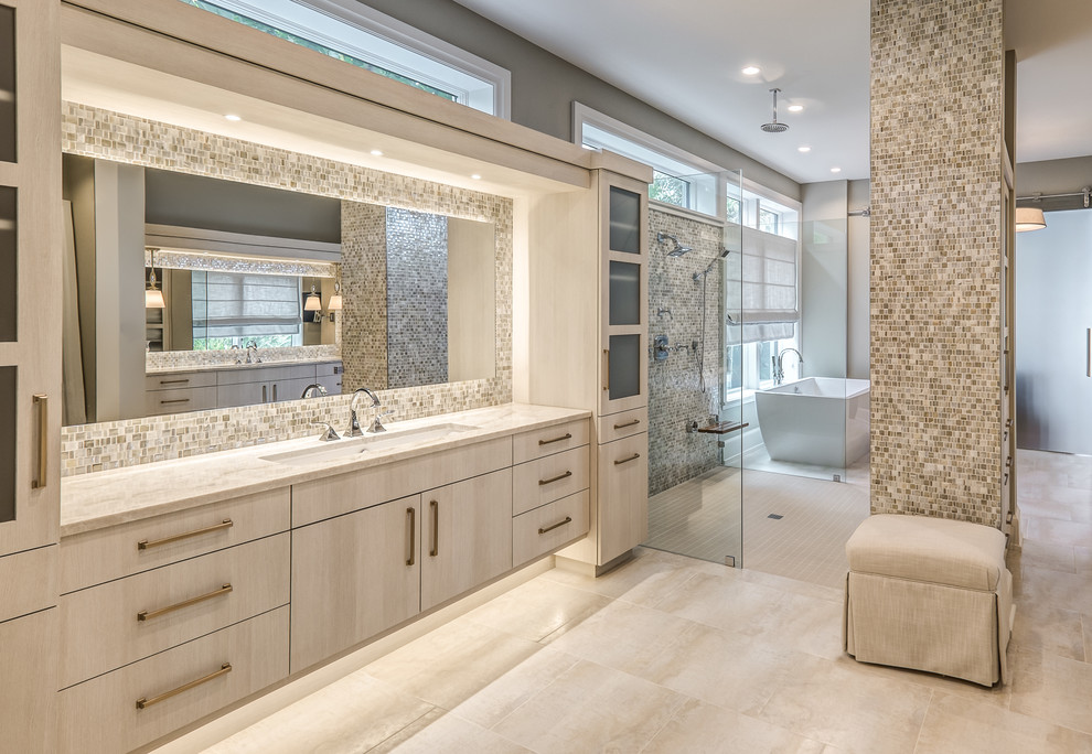 Photo of a beach style master bathroom in Other with flat-panel cabinets, light wood cabinets, a curbless shower, beige tile, mosaic tile, grey walls, an undermount sink, beige floor, an open shower and beige benchtops.