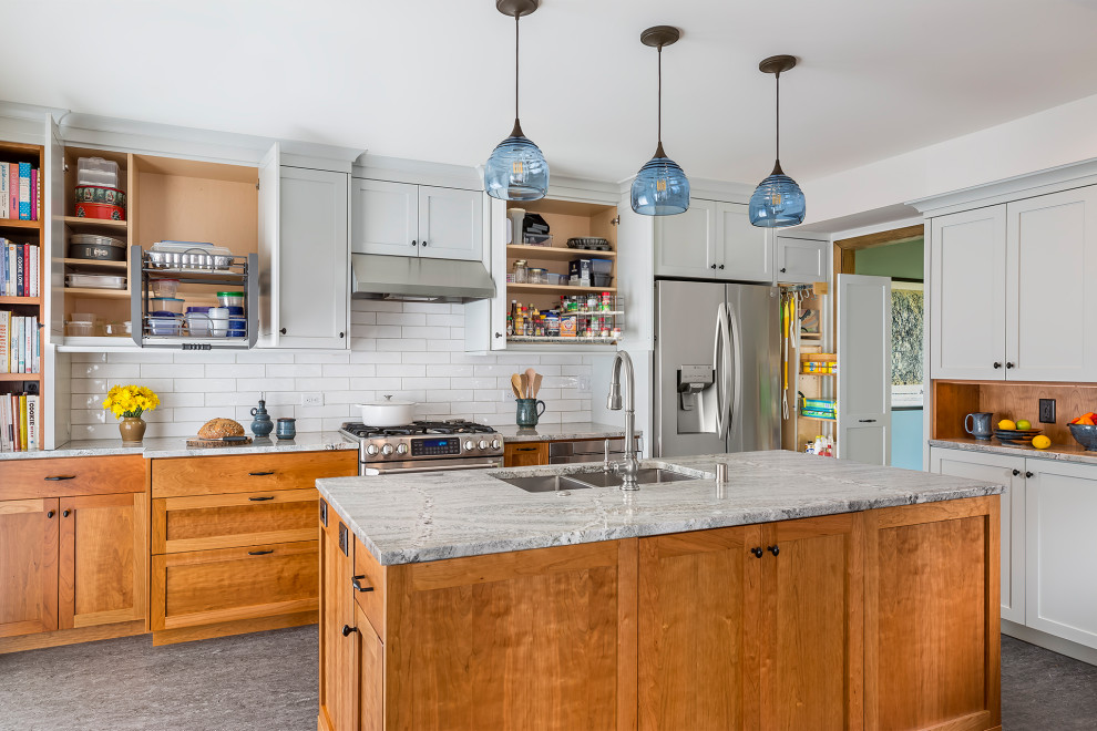 Mid-sized transitional l-shaped separate kitchen in Minneapolis with an undermount sink, shaker cabinets, blue cabinets, granite benchtops, white splashback, ceramic splashback, stainless steel appliances, linoleum floors, with island, grey floor and grey benchtop.