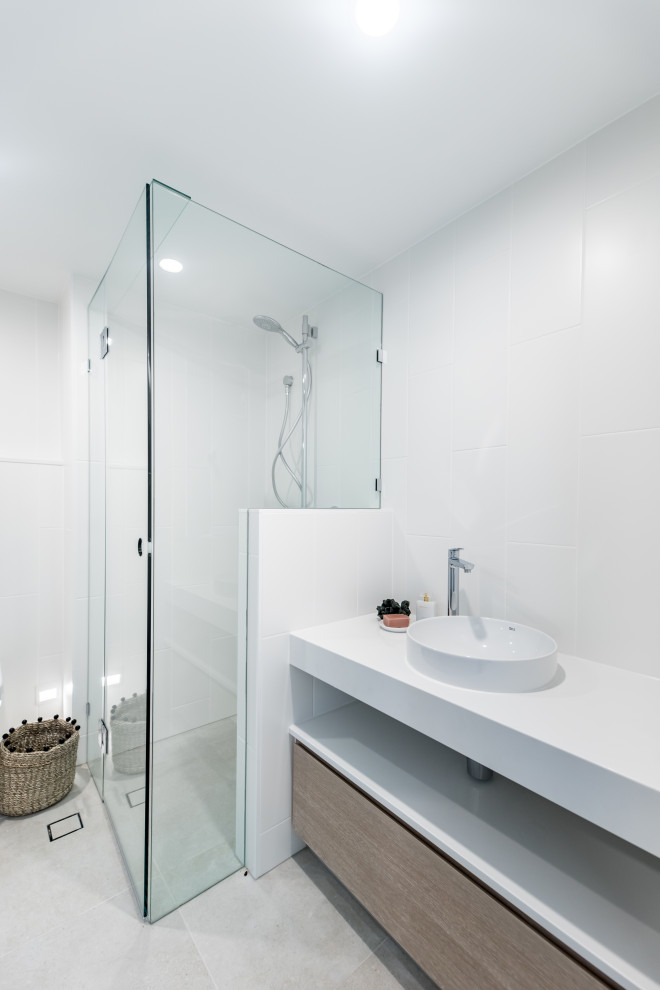 Design ideas for a small coastal bathroom in Sunshine Coast with light wood cabinets, a corner shower, white tiles, engineered stone worktops, a hinged door, white worktops, a single sink and a built in vanity unit.