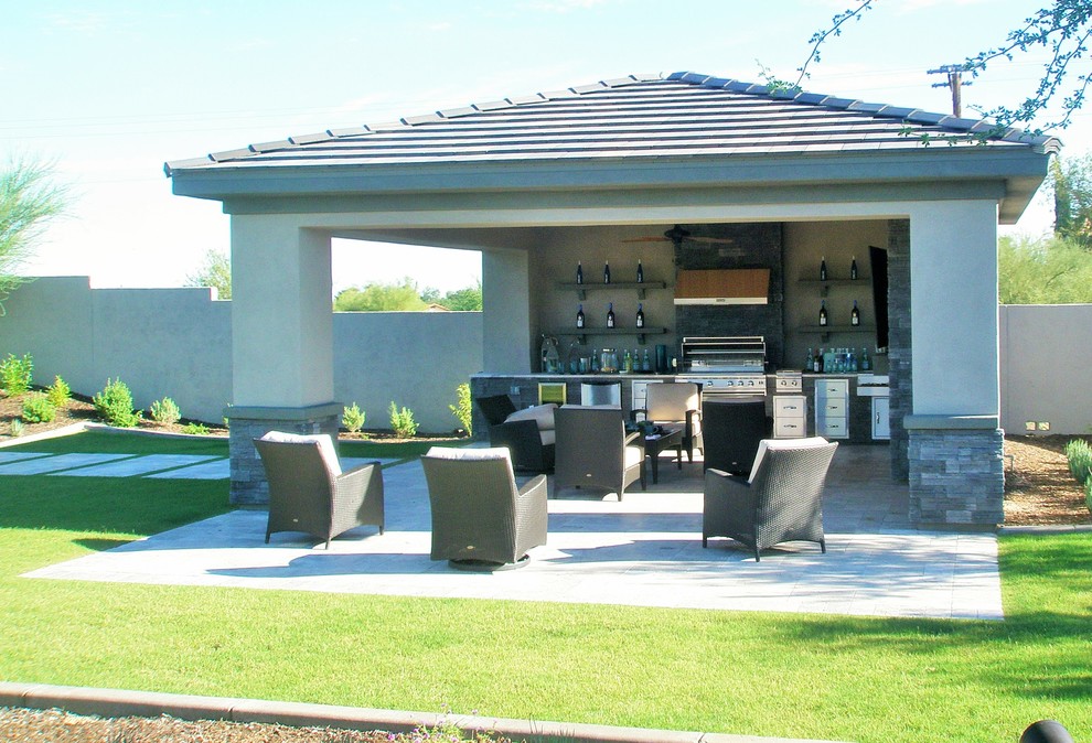 This is an example of a large modern backyard patio in Phoenix with an outdoor kitchen, concrete pavers and a gazebo/cabana.