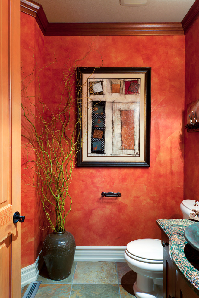 This is an example of an eclectic powder room in Portland with red walls.