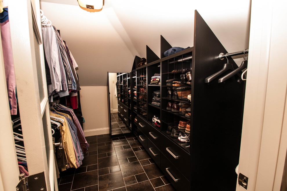 This is an example of a mid-sized contemporary men's walk-in wardrobe in Other with flat-panel cabinets, dark wood cabinets and ceramic floors.