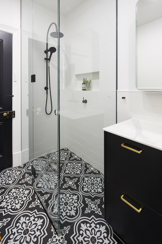 Inspiration for a small traditional kids bathroom in Melbourne with a corner shower, a wall-mount toilet, white tile, subway tile, white walls, an undermount sink, laminate benchtops, multi-coloured floor, a hinged shower door, white benchtops, furniture-like cabinets, black cabinets and porcelain floors.