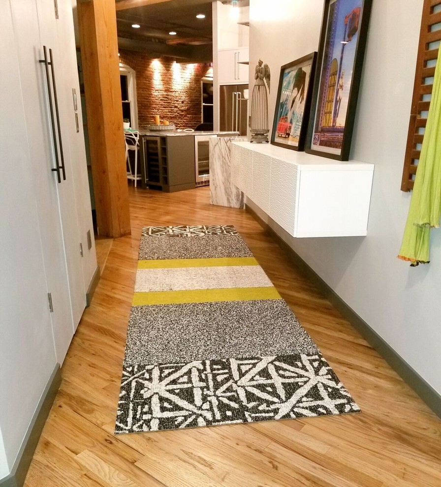 Design ideas for a mid-sized eclectic entryway in Denver with grey walls, medium hardwood floors and grey floor.