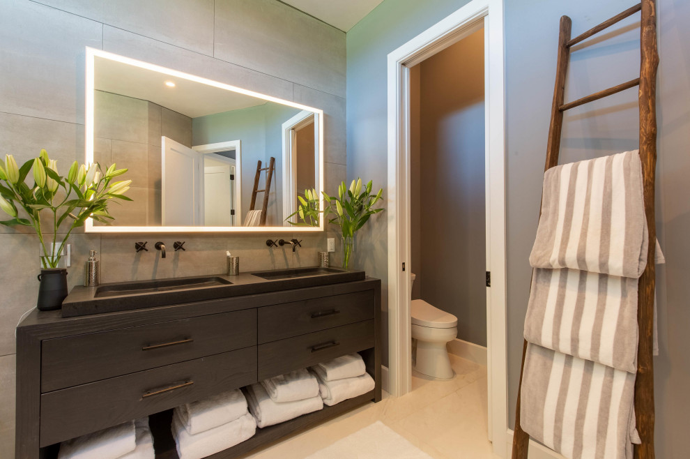 Design ideas for a mid-sized contemporary master wet room bathroom in Miami with flat-panel cabinets, black cabinets, a freestanding tub, gray tile, porcelain tile, mosaic tile floors, concrete benchtops, white floor, black benchtops, an enclosed toilet, a double vanity and a freestanding vanity.