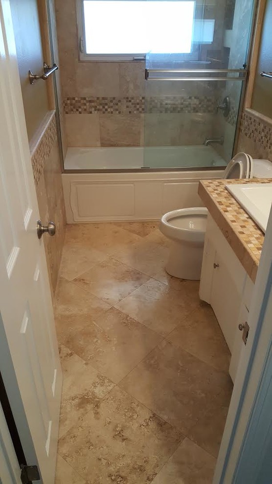Inspiration for a mid-sized traditional 3/4 bathroom in Orange County with flat-panel cabinets, white cabinets, an alcove tub, a shower/bathtub combo, a two-piece toilet, beige tile, brown tile, ceramic tile, beige walls, travertine floors, a drop-in sink and tile benchtops.