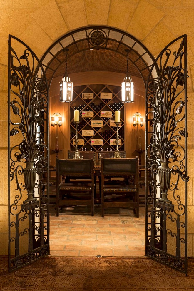 Photo of a large mediterranean wine cellar in Denver with terra-cotta floors and diamond bins.