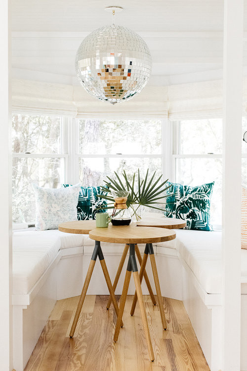 Design ideas for a small beach style open plan dining in Nashville with white walls, light hardwood floors, no fireplace and brown floor.