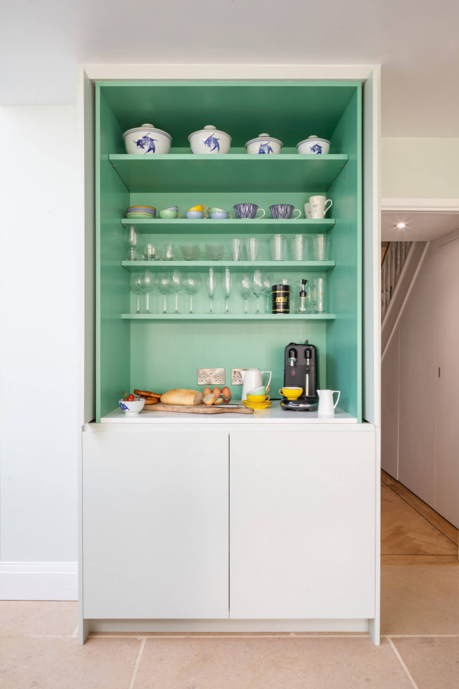 This is an example of a large scandi l-shaped open plan kitchen in Gloucestershire with flat-panel cabinets, wood worktops and a breakfast bar.