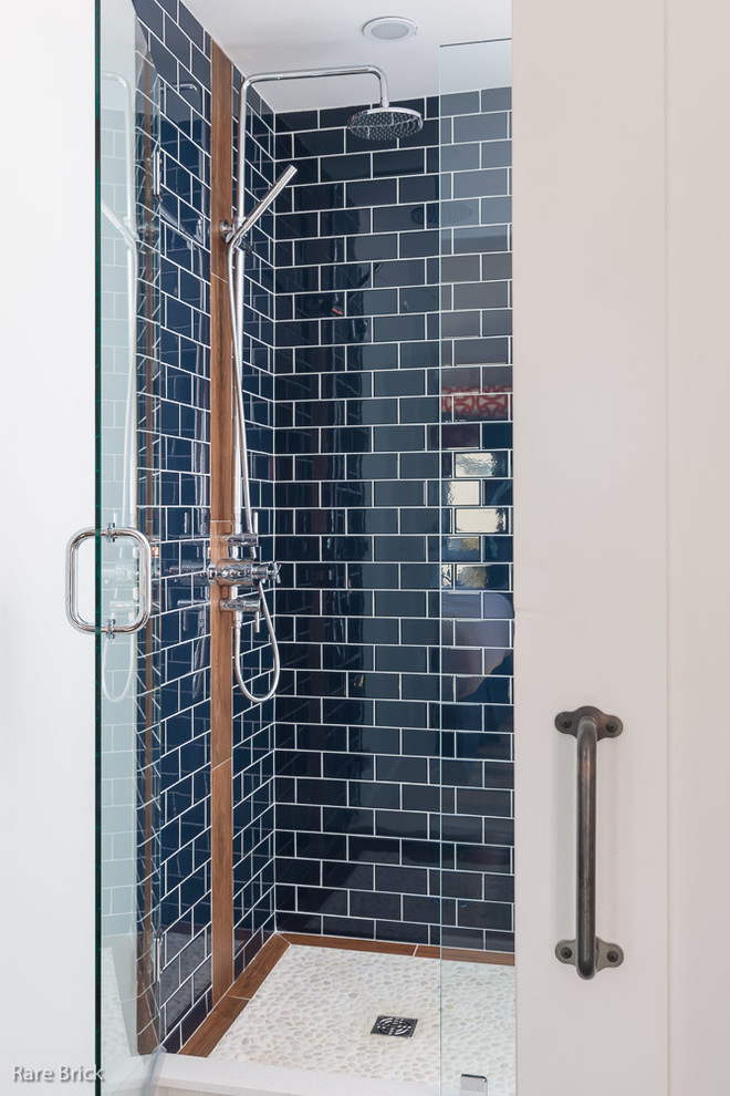 Beach style bathroom in Providence with a corner shower, blue tile and stone tile.