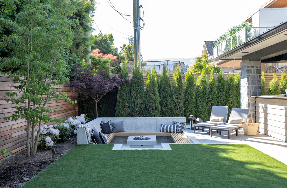 This is an example of a mid-sized contemporary backyard patio in Vancouver with a fire feature, no cover and concrete slab.