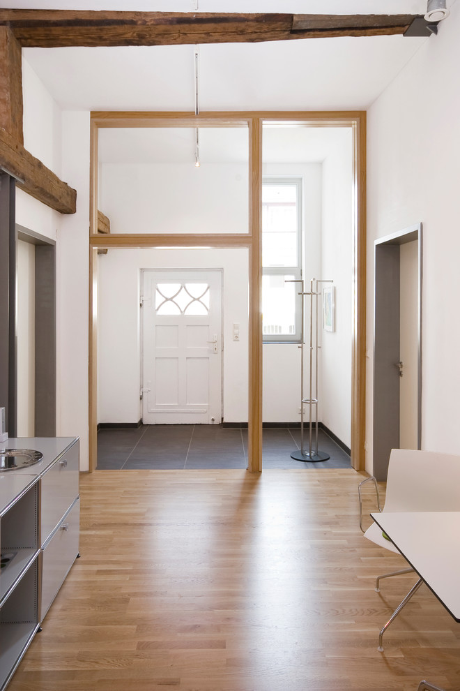 Contemporary foyer in Stuttgart with white walls, medium hardwood floors, a single front door and a white front door.