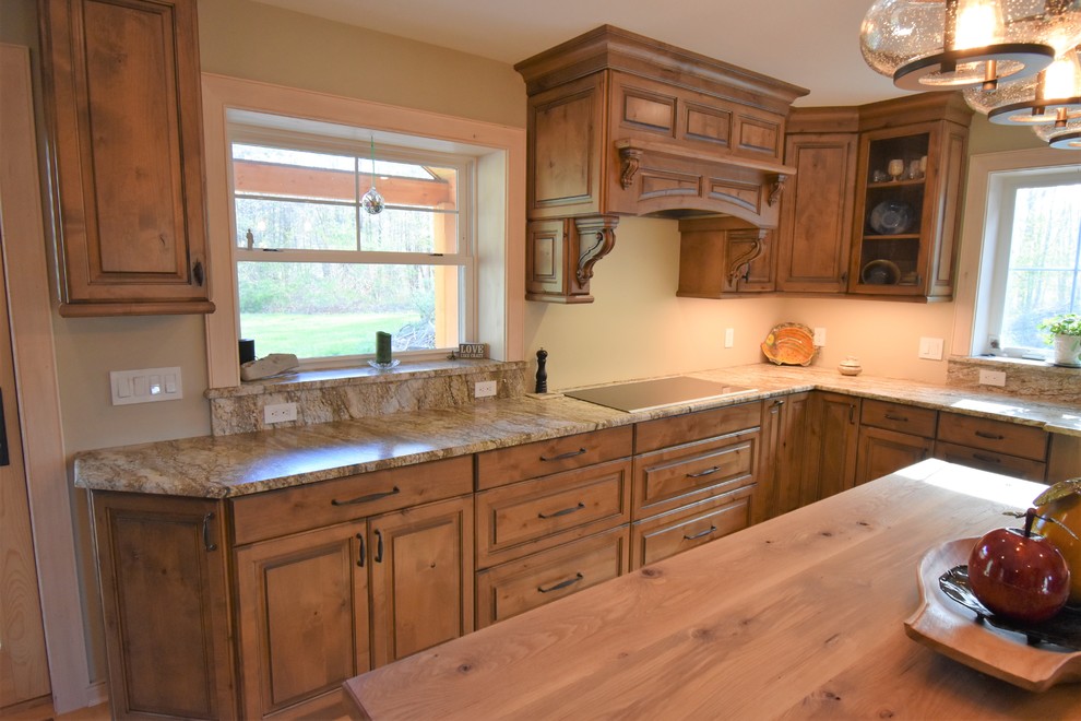 Example of a huge mountain style kitchen design with distressed cabinets