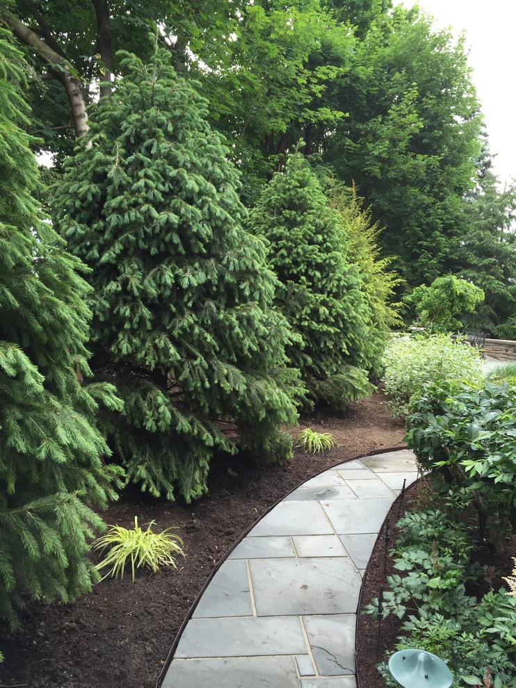 Design ideas for a mid-sized rustic partial sun backyard stone walkway.