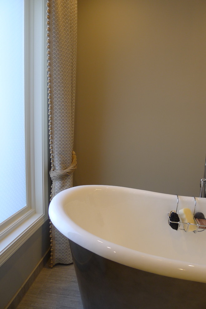 Large transitional master gray tile and porcelain tile porcelain tile freestanding bathtub photo in Indianapolis with a drop-in sink, furniture-like cabinets, dark wood cabinets, solid surface countertops, a one-piece toilet and gray walls