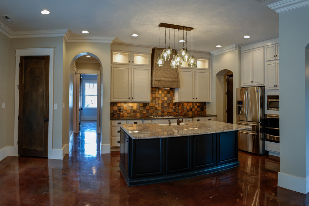 Example of a transitional concrete floor kitchen design with a farmhouse sink, raised-panel cabinets, black cabinets, granite countertops and an island