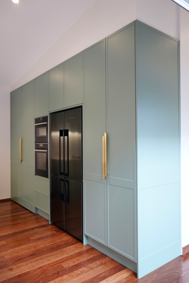Inspiration for a large modern l-shaped open plan kitchen in Sydney with an undermount sink, shaker cabinets, turquoise cabinets, marble benchtops, white splashback, matchstick tile splashback, black appliances, dark hardwood floors, with island, brown floor and white benchtop.